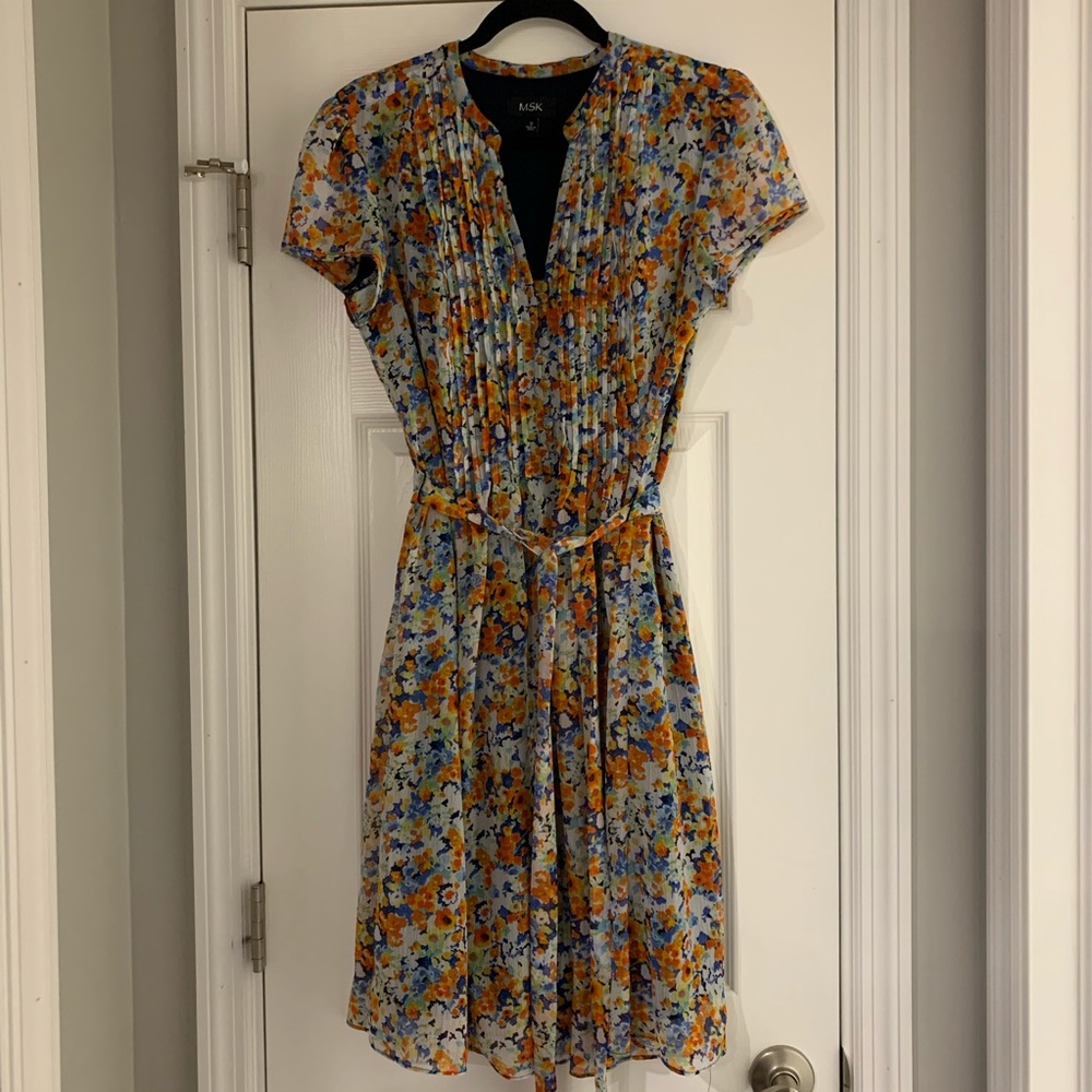 Dress pleated front. Knee length.